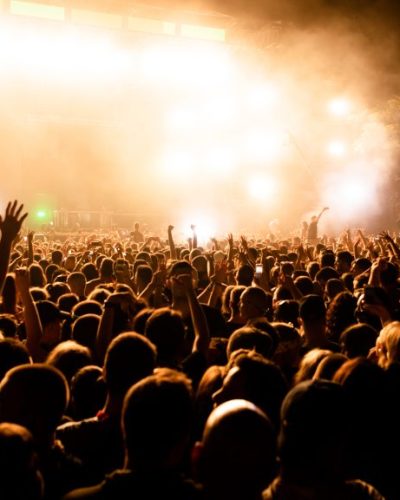Festival crowd in front of the stage at night.